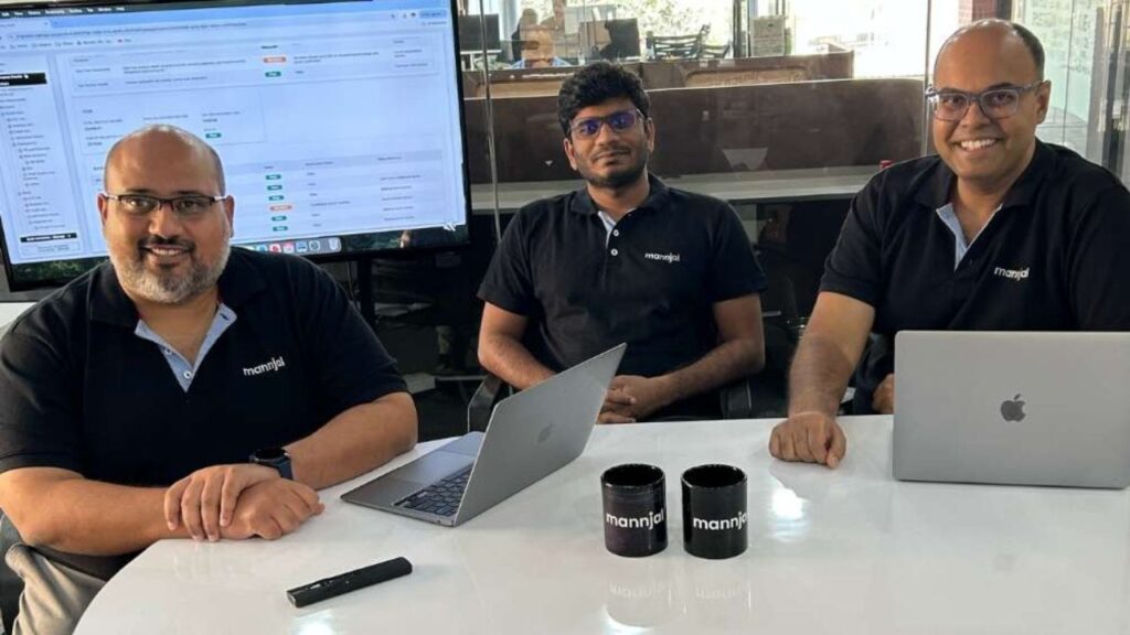 Four individuals in a meeting room.